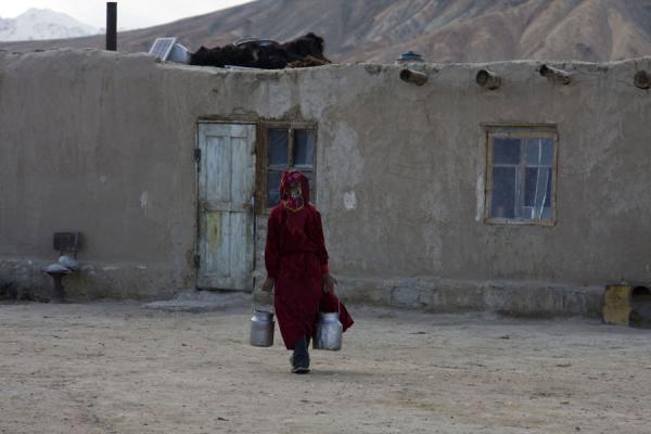 Woman walking towards her house in Bulunkul | Bulunkul | Tajikistan