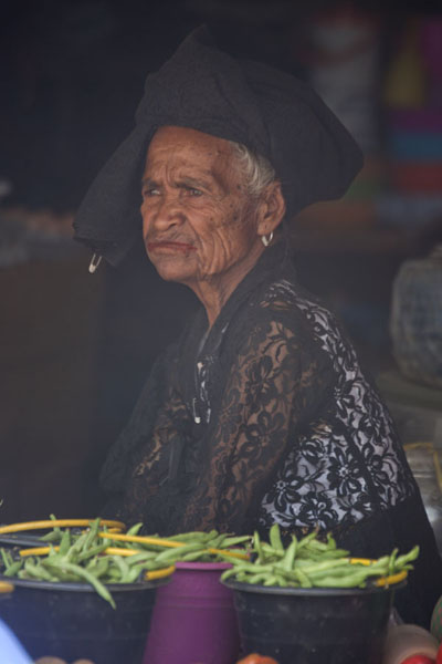 Older woman waiting for customers at a stall of the market of Maubisse | MarchÃ© de Maubisse | Timor Oriental