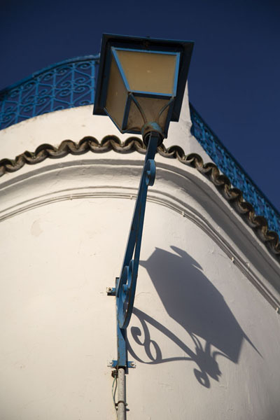 Looking up a wall with lantern in Sidi Bou Said, Tunisia