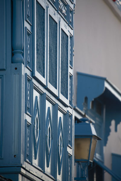 Looking up a wooden balcony painted blue in Sidi Bou Said, Tunisia