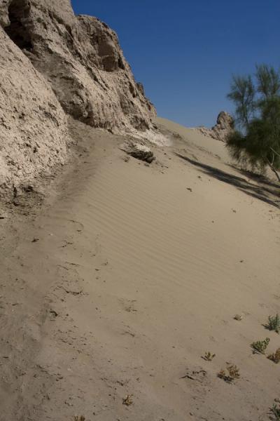 Sand dunes running down from the northern part of the city wall of Izmukshir, Izmukshir, Turkmenistan