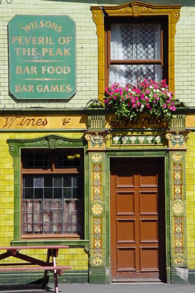 Door, windows, flowers in the southern part of Manchester, United Kingdom Door of pub in the southern part of Manchester, United Kingdom