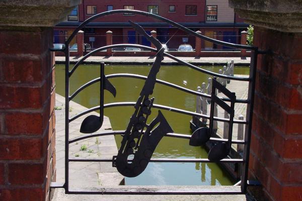 Manchester: saxophone on a bridge near Canal, United Kingdom Saxophone on bridge with Canal in the background, Manchester, United Kingdom
