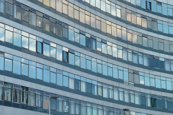 Cloudy sky reflected in one of Manchester's modern buildings, United Kingdom