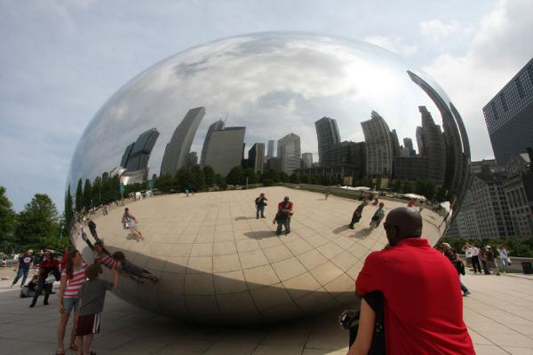 Having a look at the Chicago skyline reflected in the Bean, United States