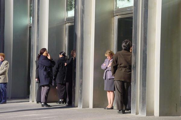 Employees having a smoke break at the entrance of the WTC, United States